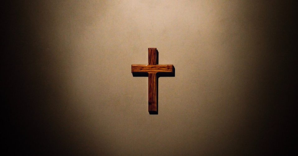 a cross on a brown background