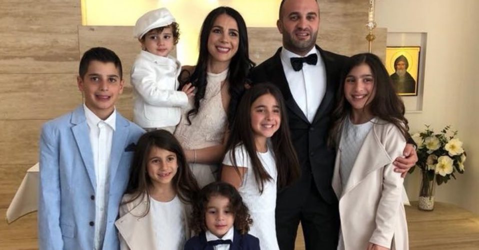 Family photo of the Abdullah Family dressed formally and smiling