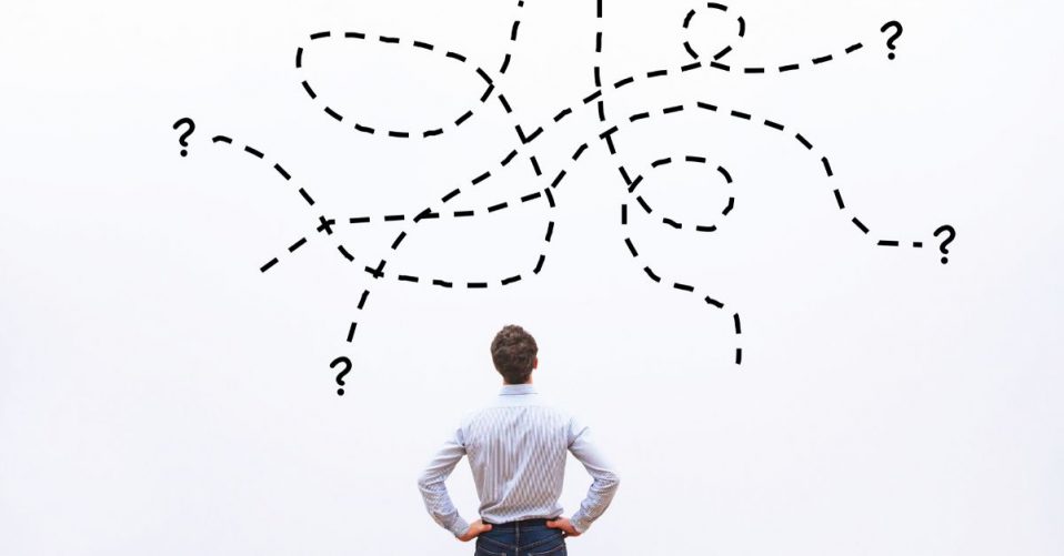 image of a man pondering an illustration of different options leading to question marks