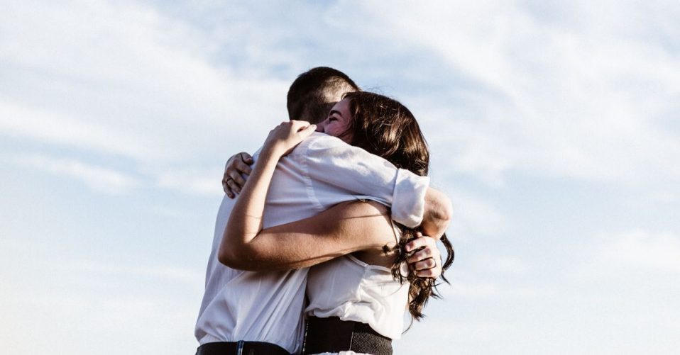 photo of man and woman in a strong embrace