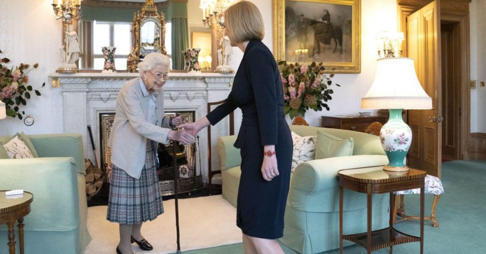 Queen Elizabeth reaching out to shake hands with new Prime Minister